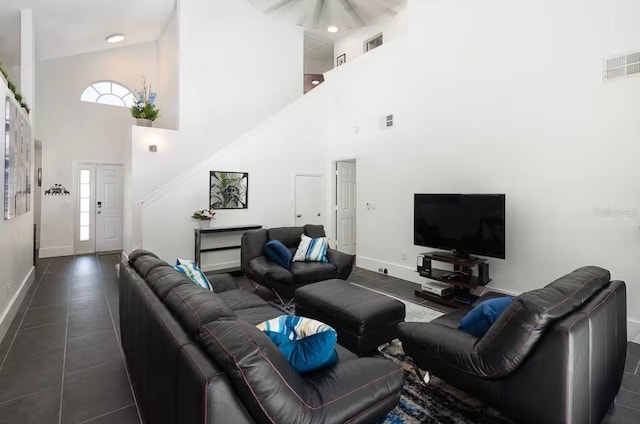 tiled living room with a high ceiling