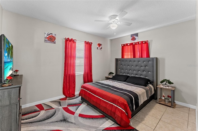 tiled bedroom with ceiling fan and a textured ceiling