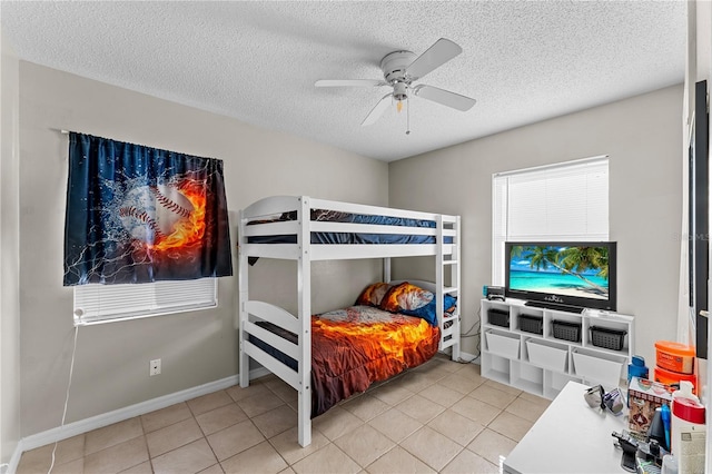 tiled bedroom featuring a textured ceiling and ceiling fan