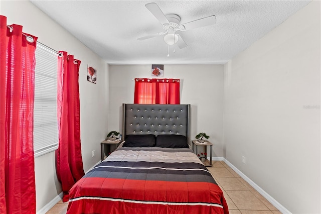 tiled bedroom with a textured ceiling and ceiling fan