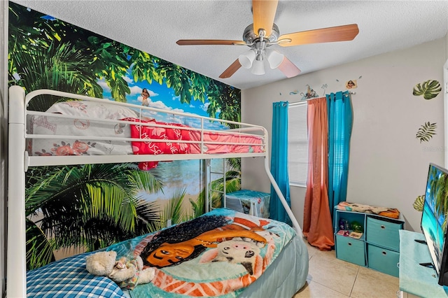 tiled bedroom featuring a textured ceiling and ceiling fan