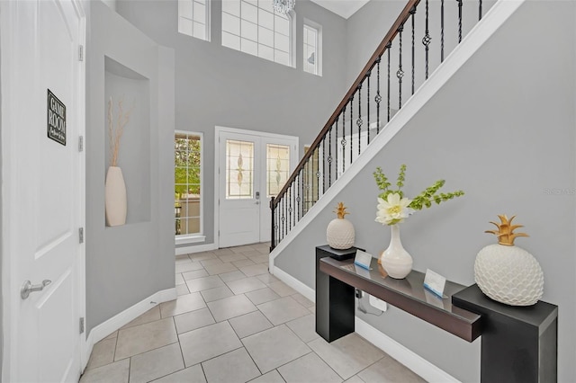 tiled foyer entrance featuring a high ceiling