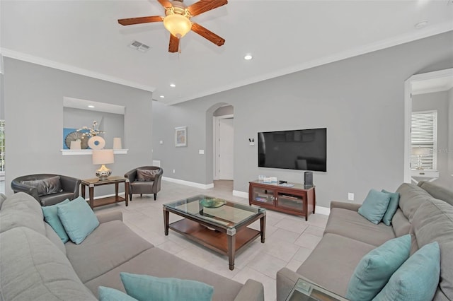 tiled living room with ceiling fan and ornamental molding