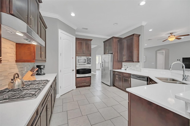 kitchen featuring stainless steel appliances, tasteful backsplash, sink, ceiling fan, and light tile patterned floors