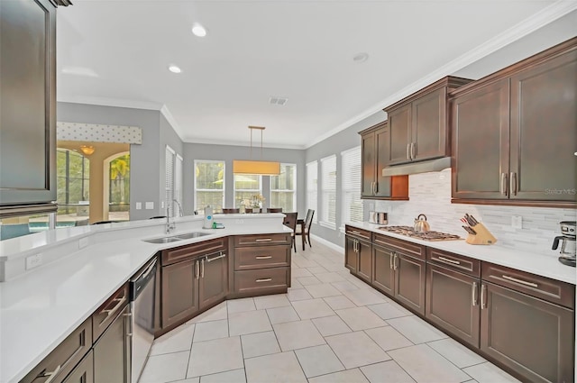 kitchen featuring appliances with stainless steel finishes, crown molding, hanging light fixtures, and sink