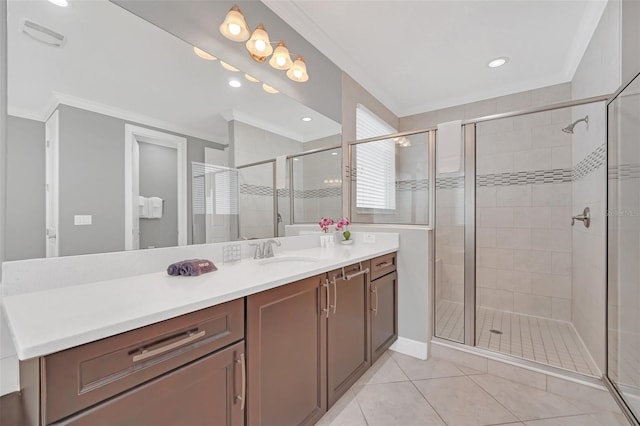 bathroom with a shower with shower door, vanity, tile patterned floors, and crown molding