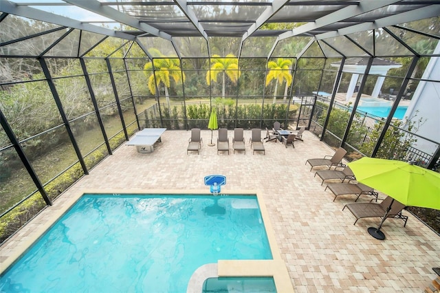 view of swimming pool with a lanai and a patio area