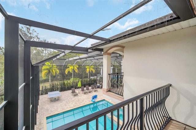 view of swimming pool with a lanai and a patio area