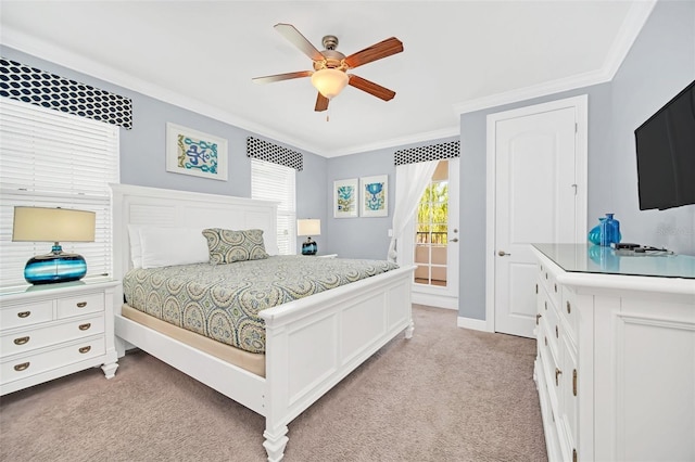 carpeted bedroom with ceiling fan and ornamental molding