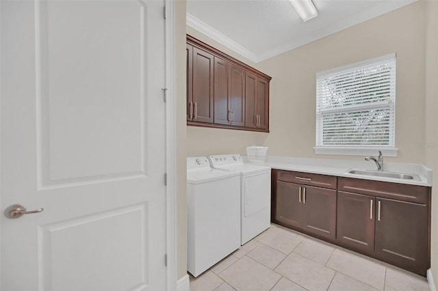 laundry room with light tile patterned floors, separate washer and dryer, cabinets, crown molding, and sink