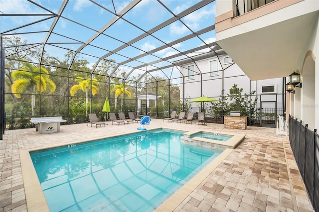 view of pool featuring an in ground hot tub, a lanai, and a patio area