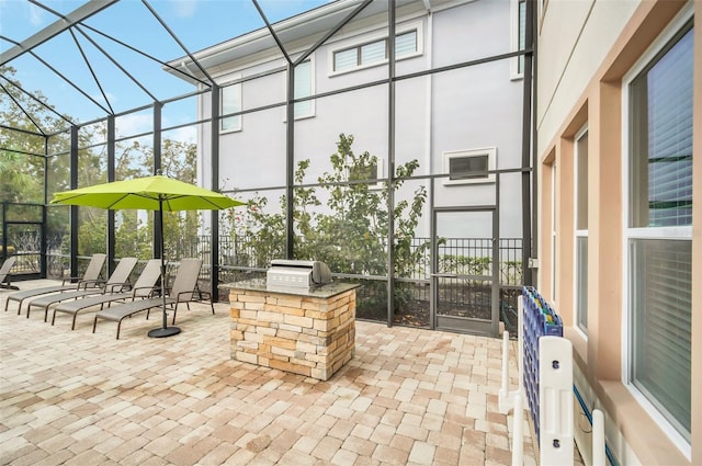 view of patio with exterior kitchen, a lanai, and grilling area