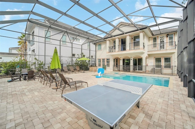 view of swimming pool with a lanai and a patio