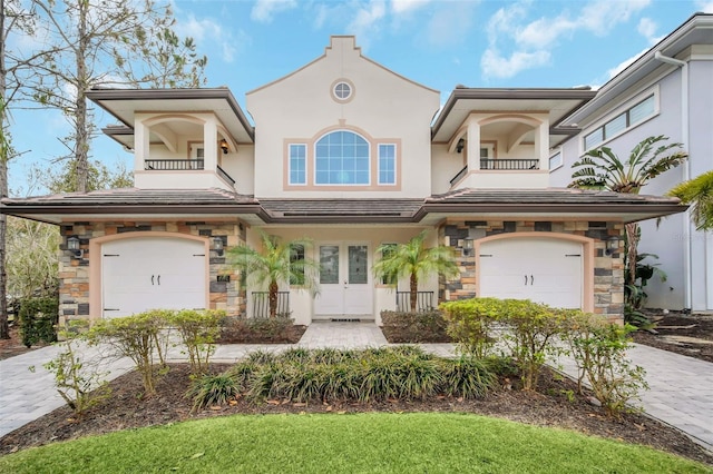 view of front of home featuring a balcony and a garage