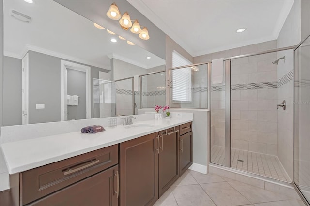 bathroom featuring vanity, an enclosed shower, crown molding, and tile patterned floors