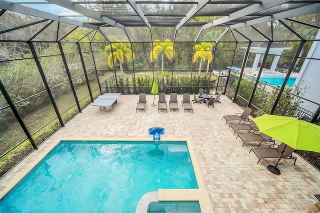 view of pool featuring a patio area and glass enclosure