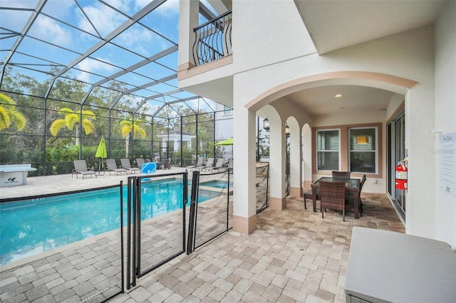 view of swimming pool with a lanai and a patio