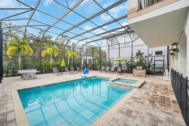 view of swimming pool featuring an in ground hot tub, a lanai, and a patio area