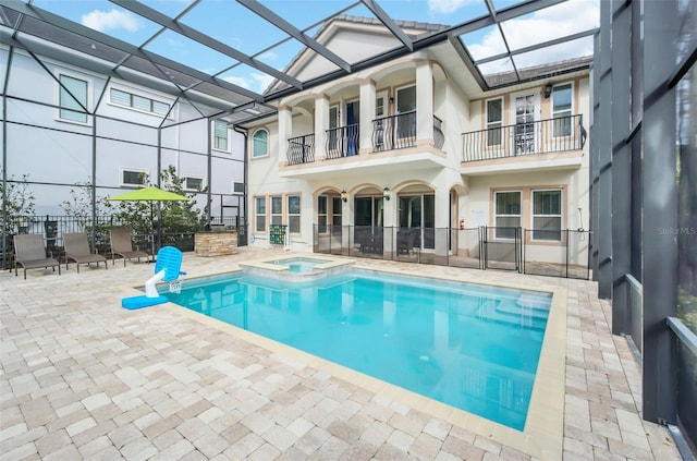 view of pool featuring a lanai, a patio, and an in ground hot tub