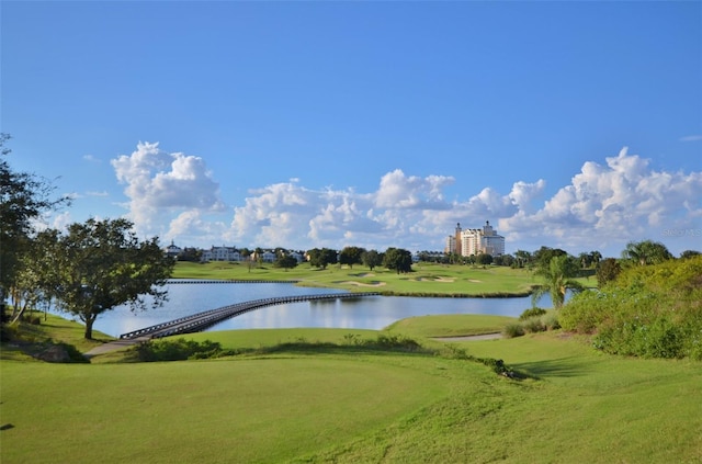 view of community with a water view and a yard