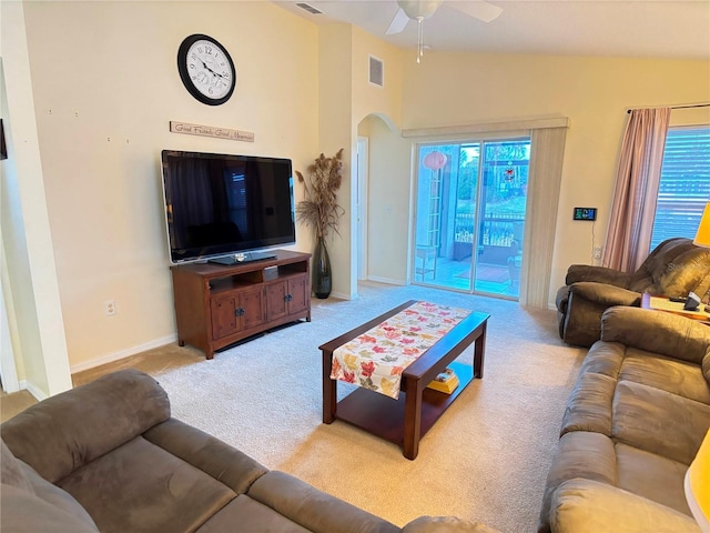 carpeted living room featuring ceiling fan, plenty of natural light, and lofted ceiling