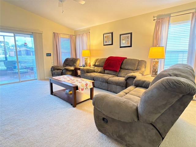 carpeted living room with vaulted ceiling and ceiling fan