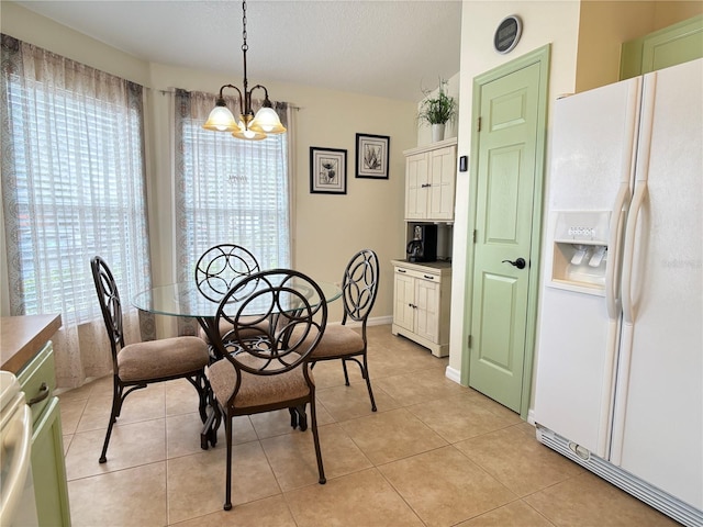 dining room featuring a wealth of natural light, light tile patterned flooring, and a chandelier