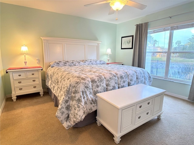 bedroom featuring light carpet and ceiling fan