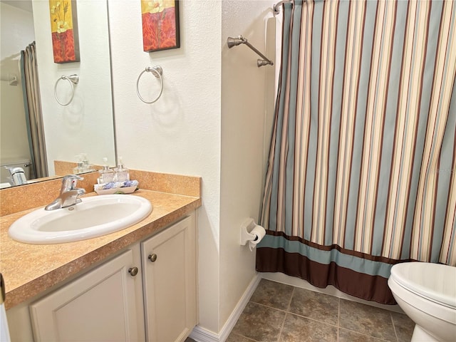 bathroom with vanity, toilet, and walk in shower