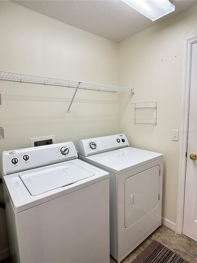 clothes washing area with washer and clothes dryer