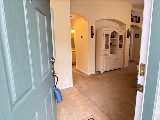 view of carpeted foyer entrance