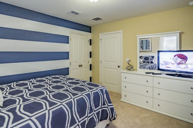 carpeted bedroom featuring a textured ceiling