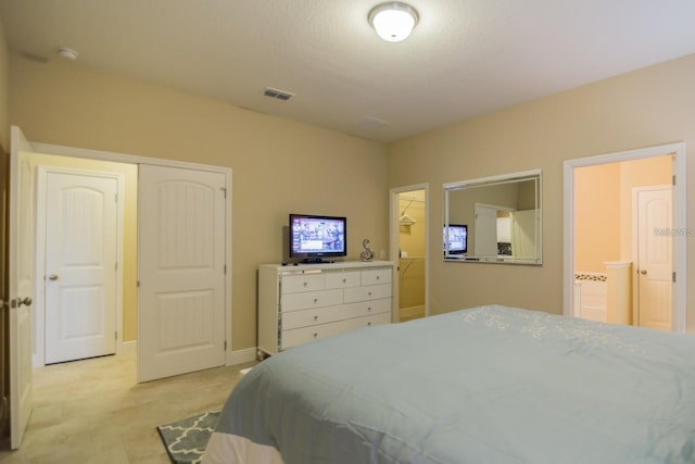 bedroom featuring ensuite bathroom and a closet