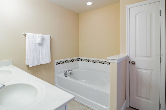 bathroom featuring a tub to relax in and vanity