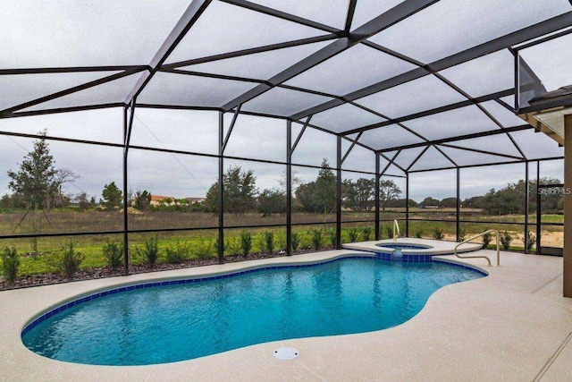 view of swimming pool featuring glass enclosure, a patio area, and an in ground hot tub