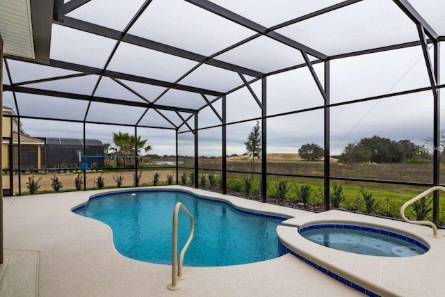 view of pool with an in ground hot tub, a patio, and a lanai