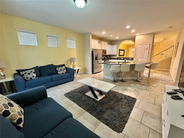 tiled living room featuring sink