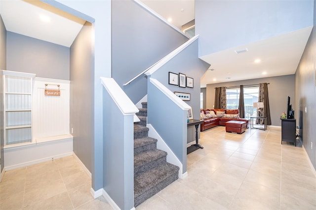 stairway featuring tile patterned flooring