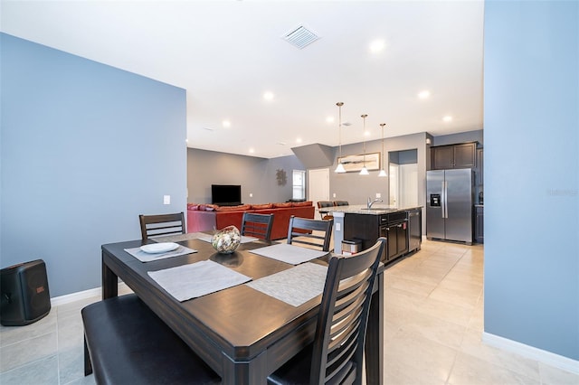 dining room featuring light tile patterned floors and sink