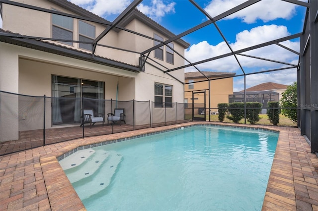 view of pool with a lanai and a patio