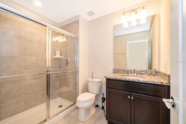 bathroom with tile patterned floors, vanity, toilet, and walk in shower