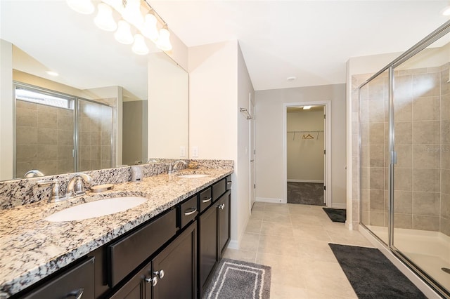 bathroom featuring tile patterned flooring, vanity, and a shower with shower door