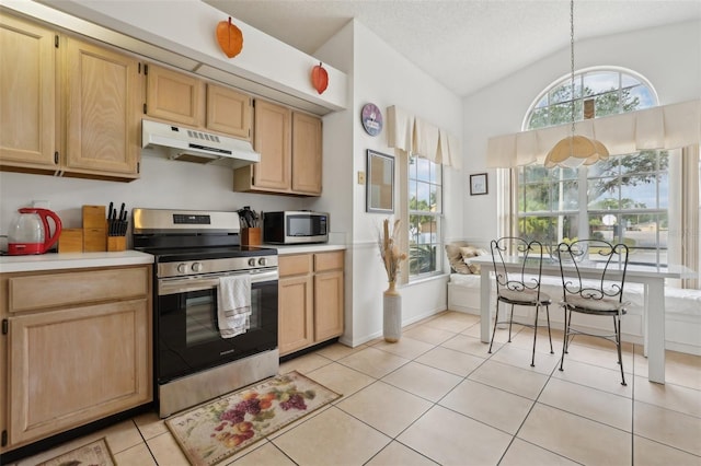 kitchen featuring appliances with stainless steel finishes, light brown cabinetry, vaulted ceiling, light tile patterned floors, and pendant lighting