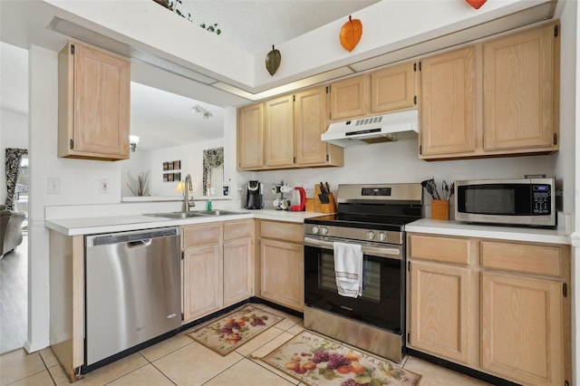 kitchen featuring light tile patterned flooring, appliances with stainless steel finishes, light brown cabinetry, and sink