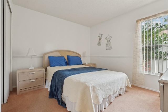 bedroom with light colored carpet