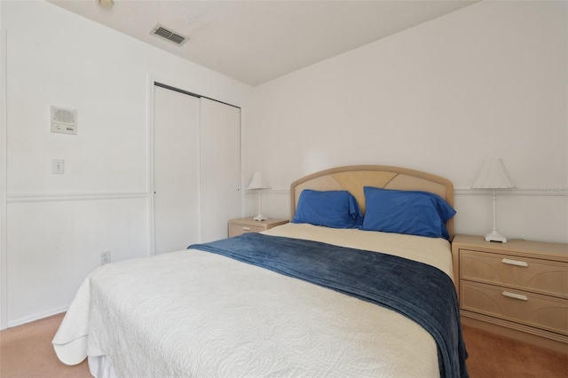 carpeted bedroom featuring a closet