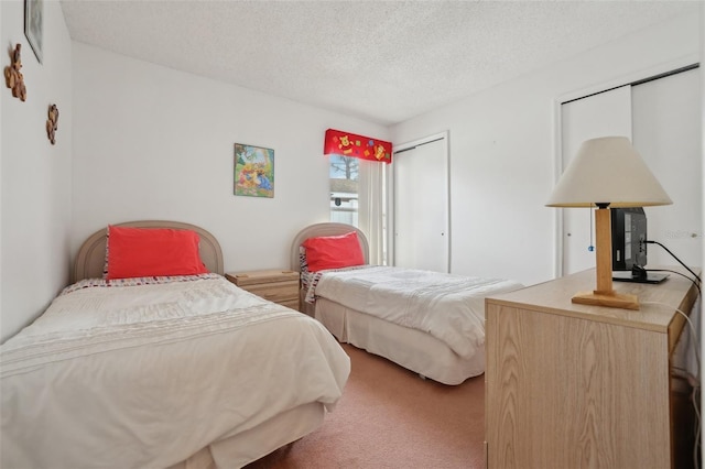 carpeted bedroom featuring a textured ceiling