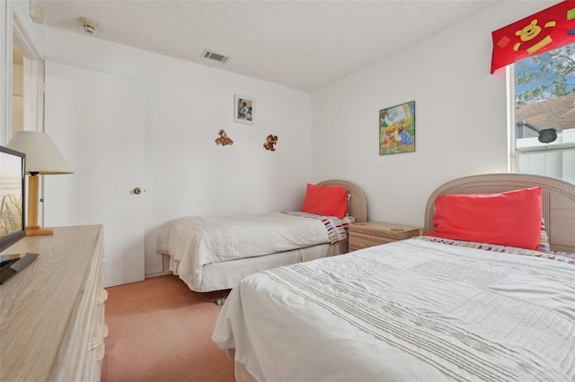 carpeted bedroom featuring a textured ceiling