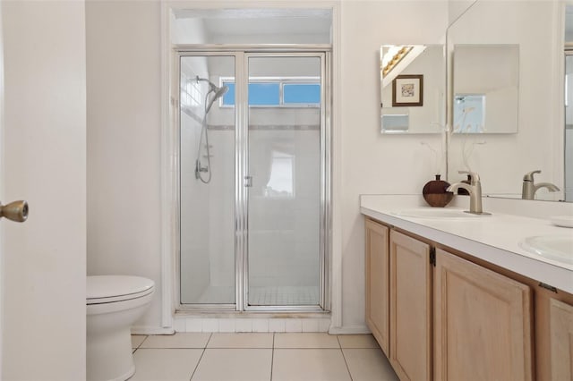 bathroom featuring tile patterned floors, a shower with door, vanity, and toilet