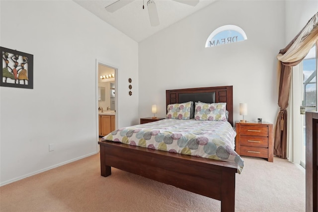 carpeted bedroom with high vaulted ceiling, ceiling fan, sink, and connected bathroom